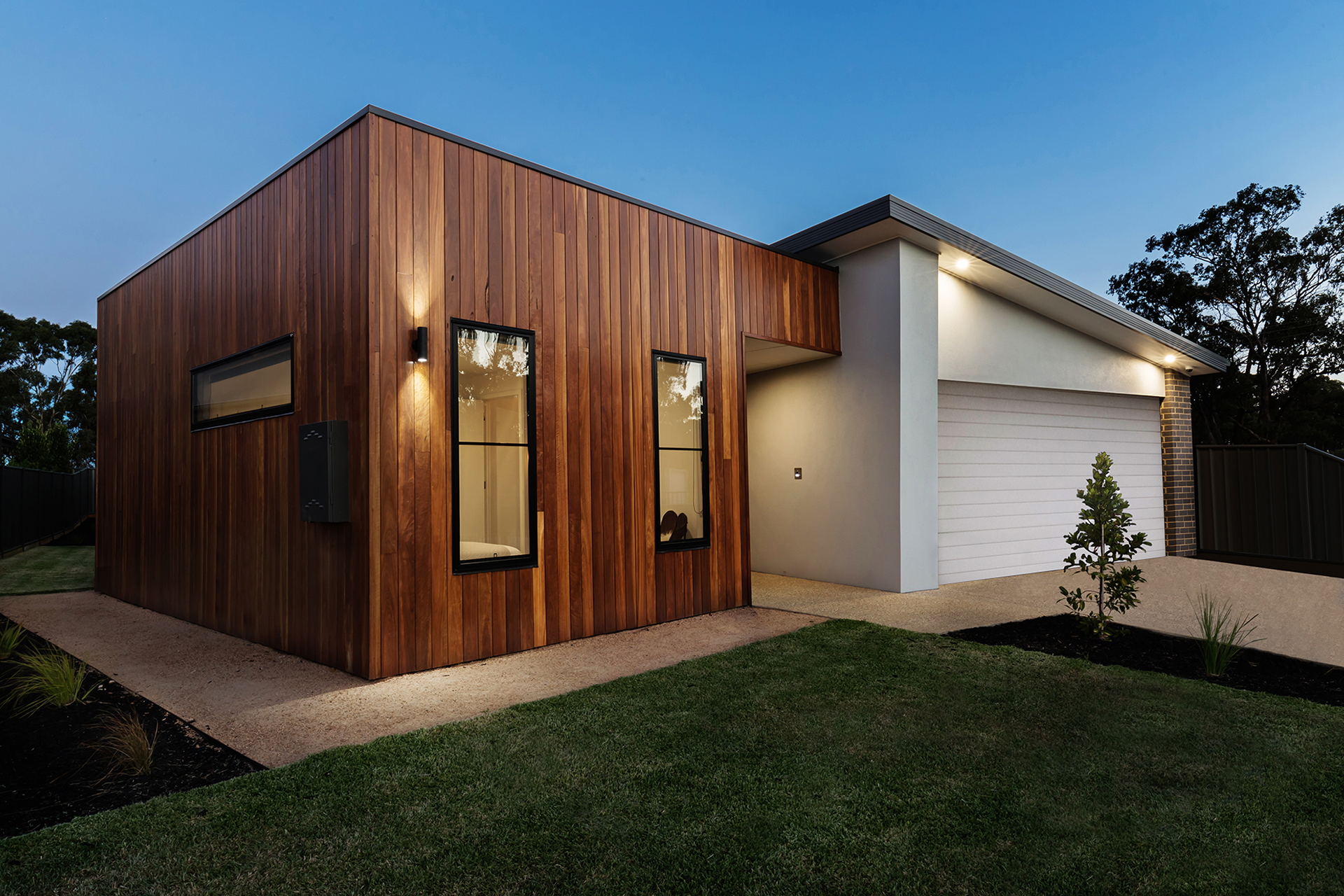Modern white garage door installed on wood-accented home in Studio City
